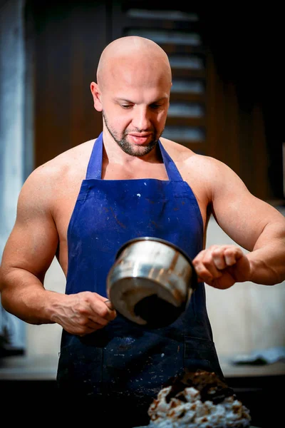 A young man is cooking in a large kitchen — Stock Photo, Image