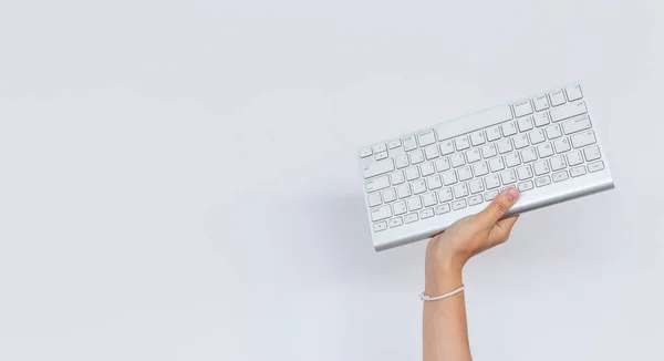 business, work hard concept. hand holding keyboard computer with on white background