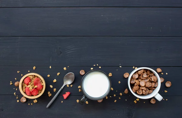 homemade granola with milk for breakfast on wooden table. top view