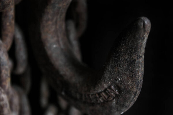 old chain hook on black background