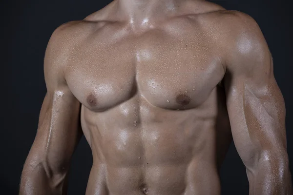 Man training with weight in dramatic studio light