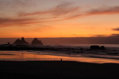 Günbatımı, Yeni Zelanda 'nın en dramatik manzaralarından biri olan Motukiekie' de, Güney Adası 'nın batı kıyısında..