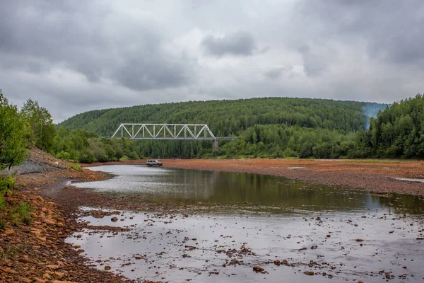 Railway bridge across the contaminated river Kosva — Stock Photo, Image