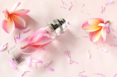 Perfume and beautiful flowers on sweet background