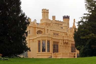 Front facade of palace in Lednice Chateau, Czech Republic surrounded by big green park clipart