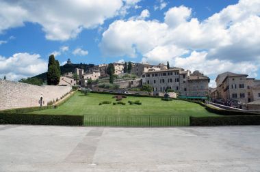 Outside the Basilica of San Francesco d'Assisi in Italy - view on Assisi and the park clipart
