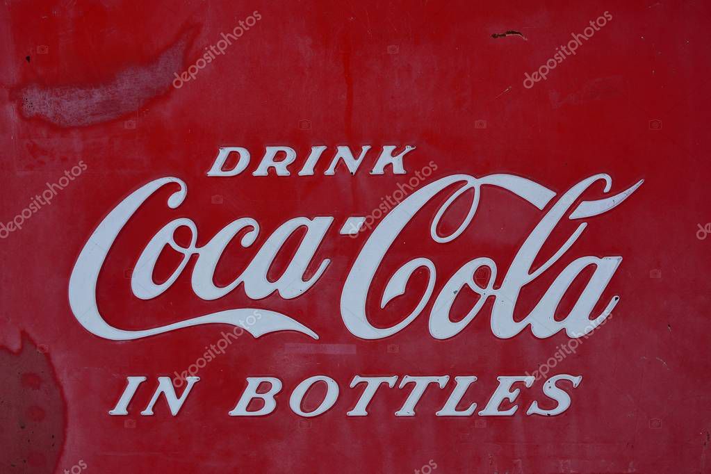 Rolla, Missouri - July 18, 2017: Sign of Coca-Cola painted in a rusty and old metal. Coca-Cola is a carbonated soft drink produced by The Coca-Cola Company.