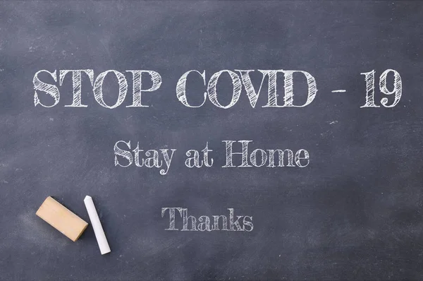 Coronavirus pandemic behaviour rules or health advice. Stop Covid-19, Stay at Home, Thanks chalkboard inscription.