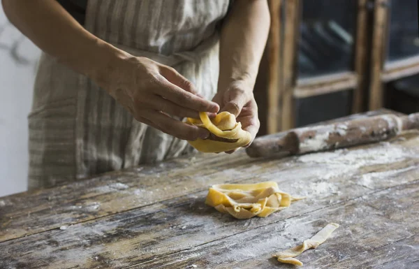 The young man prepares homemade pasta at rustic kitchen — Stock Photo, Image