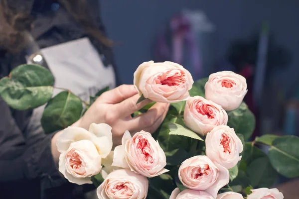 Roses on the florist\'s table, working moments