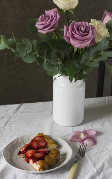 Обеденный стол с цветами и клубничным пирогом в деревенском стиле — стоковое фото