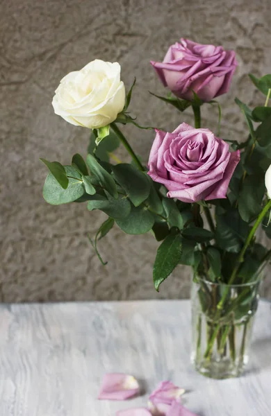 Delicate bouquet of light purple and white roses and eucaliptus