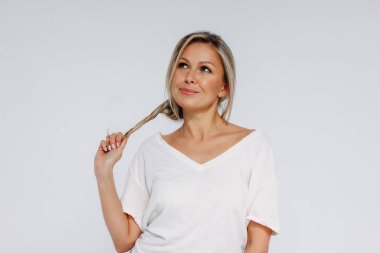 Çekici, sarışın, gülümseyen bir kadın. 35 yaşında. Temiz, taze bir yüzü var.