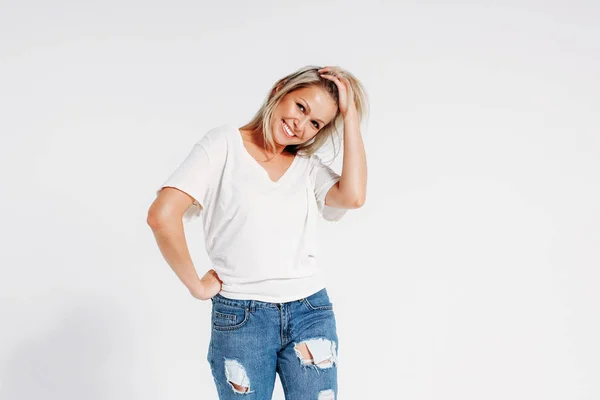 Blonde hair happy woman 35 year plus in white t-shirt and blue jeans isolated on white background — 스톡 사진