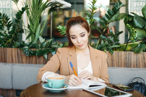 Young Brunette Girl Student Doing Homework Notebook Tablet Coffee Cafe — Stock Photo, Image