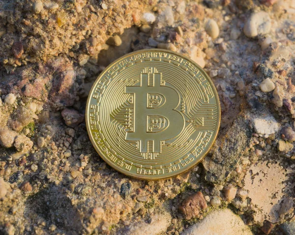 Golden bitcoin on stone surface. Close-up view — Stock Photo, Image