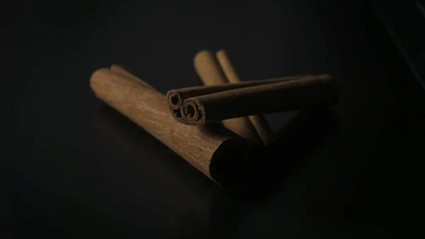 Paus de canela no fundo preto. vista lateral — Fotografia de Stock