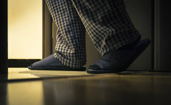 Adult man in pijamas walks to a bathroom at the night. Men's healths concept — Stock Photo, Image