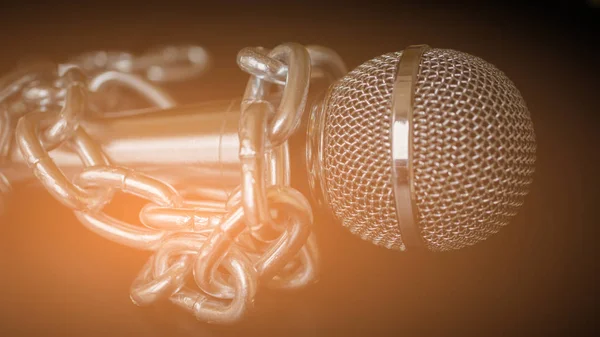 Microphone and chain. Freedom of the press is at risk concept - World press freedom day concept