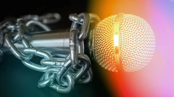 Microphone and chain. Freedom of the press is at risk concept - World press freedom day concept