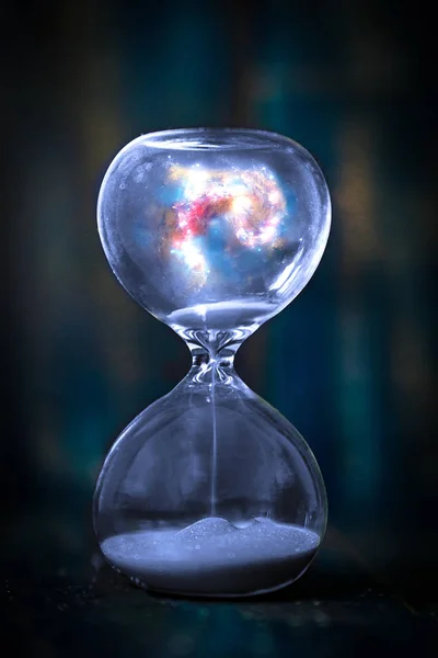 Space and galaxy in hourglass. Life time passing concept. Sand running through the bulbs of hourglass measuring passing time in a countdown to a deadline. Elements of this image furnoshed by NASA — Φωτογραφία Αρχείου