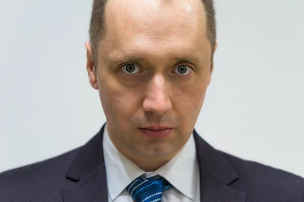 Portrait of a confident, purposeful, successful businessman weared in grey suit and blue neck tie — Stock Photo, Image