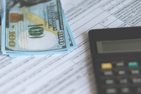 Business and tax concept. Tax form 1040, pen and calculator on the desk. Taxation concept