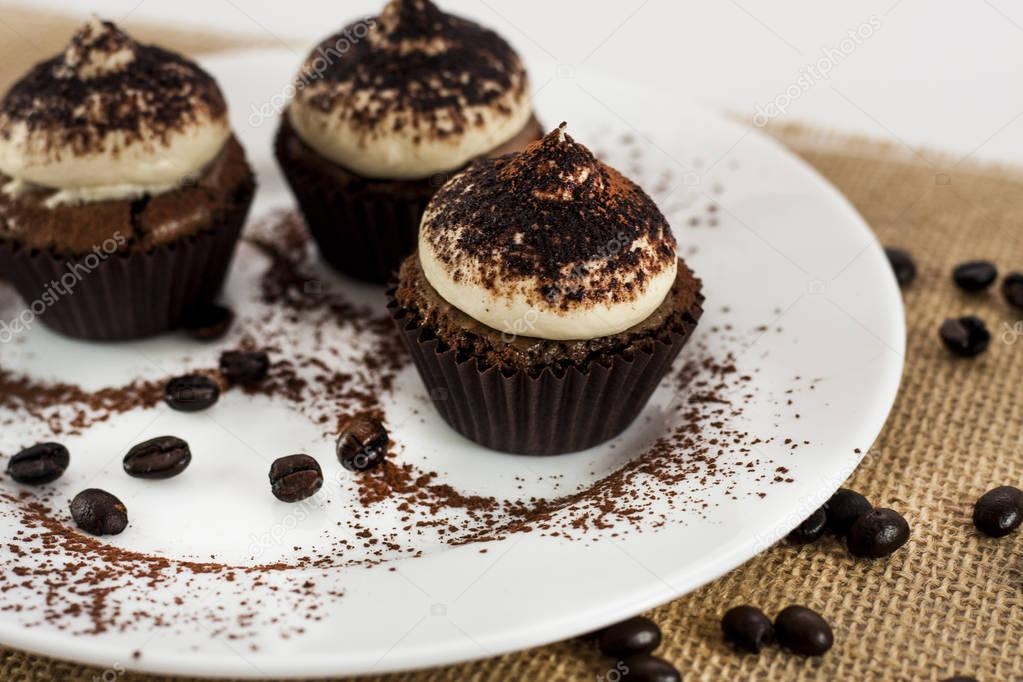 Tiramisu Cupcakes on white round plate, missing one