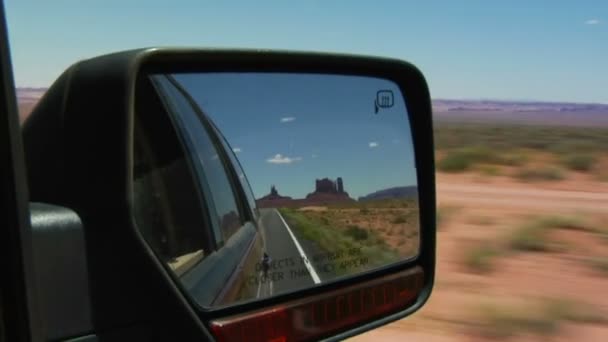 Monument valley highway in rearview mirror — Stock Video