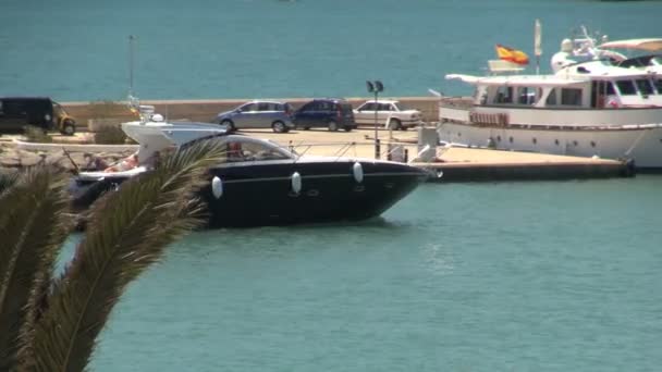 Motorboat cruises through spanish harbor — Stock Video