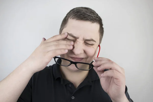 男は白い背景に手で疲れた目をこすりつける コンピュータからの目の疲労と仕事からの疲労の概念 眼と額の痛み 片頭痛 眼疾患 — ストック写真