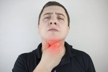 A man touches a sore throat and neck, twists from irritation and inflammation. Sore throat when swallowing, suspected pharyngitis or acid reflux. clipart