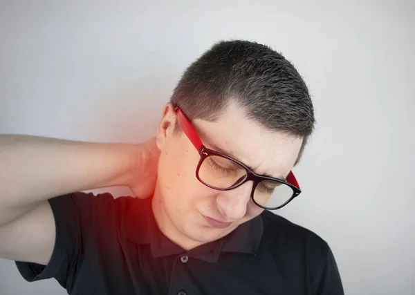 A man suffers from pain in the neck, massages the cervical spine with his hand. Osteochondrosis, hernia, or nerve injury due to sedentary work or physical stress — Stock Image Man Suffers Pain Neck Massages Cervical Spine His Hand Osteochondrosis Stock Image