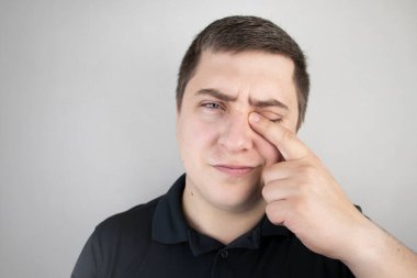 Bir adam gözündeki acıdan muzdariptir. Göz hastalığı, uveit, optik sinir iltihabı, konjonktivit veya göz hasarı olan bir hasta.