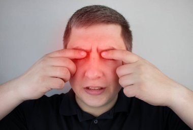 A man suffers from pain in the eye. Patient with ophthalmic disease, uveitis, optic neuritis, conjunctivitis, or eye injury clipart