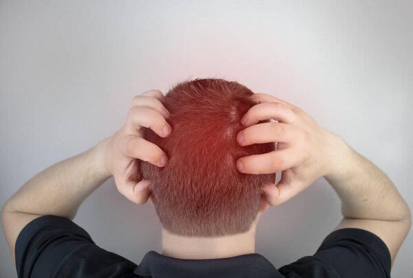 A man suffers from pain in the back of his head. Signs of cervical osteochondrosis, spondylosis, myositis, or hypertension. The concept of acute pain in different parts of the body