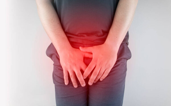Man front view. Pain in the groin and bladder. The concept of pain in men as a result of prostatitis, inflammation of the bladder or genitourinary system. Frequent urination.
