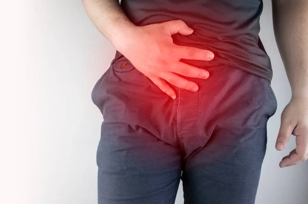 Man front view. Pain in the groin and bladder. The concept of pain in men as a result of prostatitis, inflammation of the bladder or genitourinary system. Frequent urination. — Stock Image Man Front View Pain Groin Bladder Concept Pain Men Result Stock Image