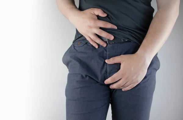Man front view. Pain in the groin and bladder. The concept of pain in men as a result of prostatitis, inflammation of the bladder or genitourinary system. Frequent urination. — Stock Image Man Front View Pain Groin Bladder Concept Pain Men Result Stock Picture