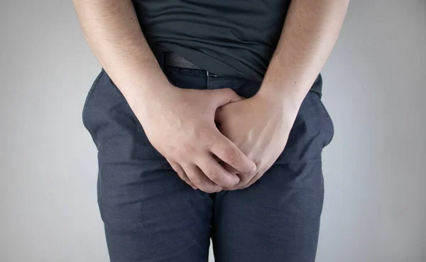 Man front view. Pain in the groin and bladder. The concept of pain in men as a result of prostatitis, inflammation of the bladder or genitourinary system. Frequent urination. — Stock Image Man Front View Pain Groin Bladder Concept Pain Men Result Royalty Free Stock Photos