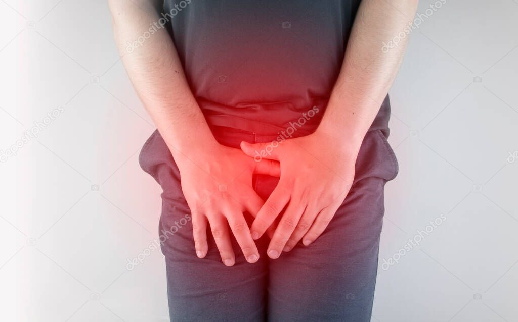 Man front view. Pain in the groin and bladder. The concept of pain in men as a result of prostatitis, inflammation of the bladder or genitourinary system. Frequent urination.