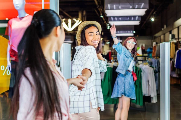 Multicultural girls in shopping mall — Stock Photo