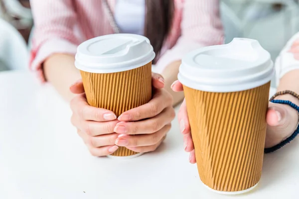 Women holding cups of coffee — Stock Photo