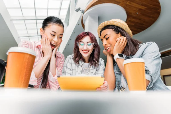 Friends using digital tablet — Stock Photo