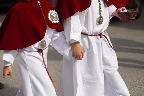 Interlaced hands in a procession, Holy Week