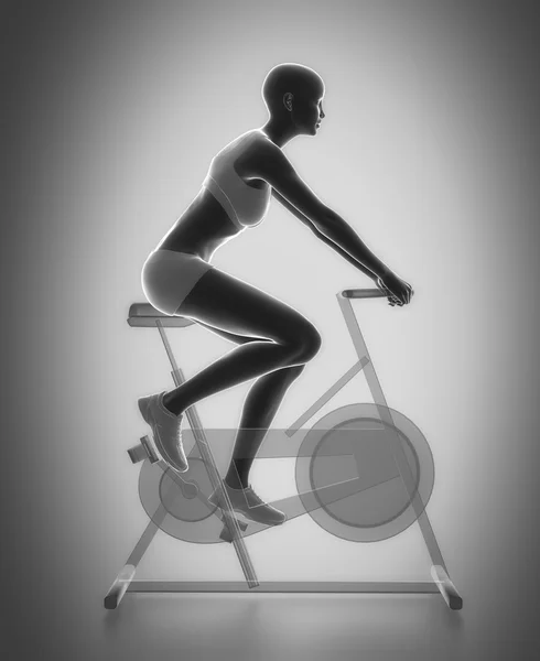 Vrouw riding gymnastiek fiets — Stockfoto