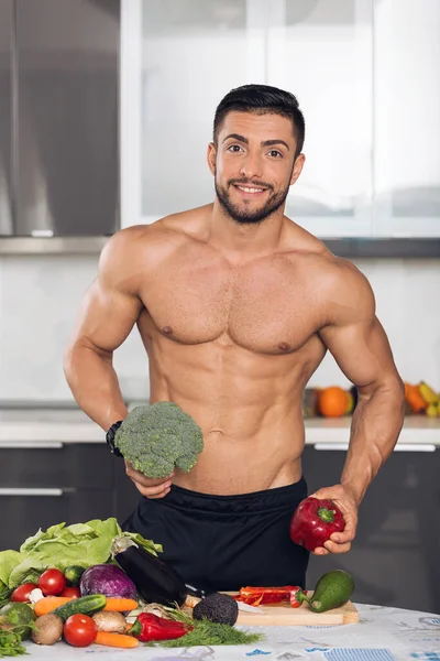 Young Fit Bodybuilder Kitchen Cooking Cutting Vegetables Stock Picture