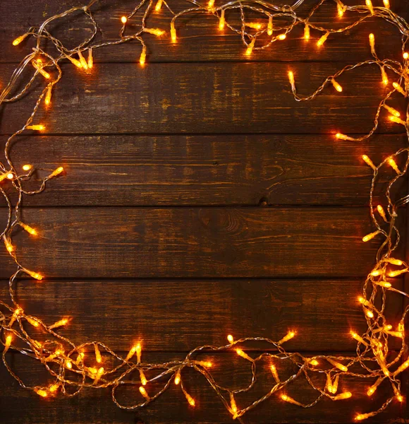 Fundo de madeira com luzes brilhantes com um espaço livre para texto — Fotografia de Stock