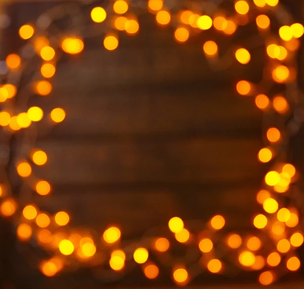 Fundo de madeira com luzes brilhantes com um espaço livre para texto — Fotografia de Stock