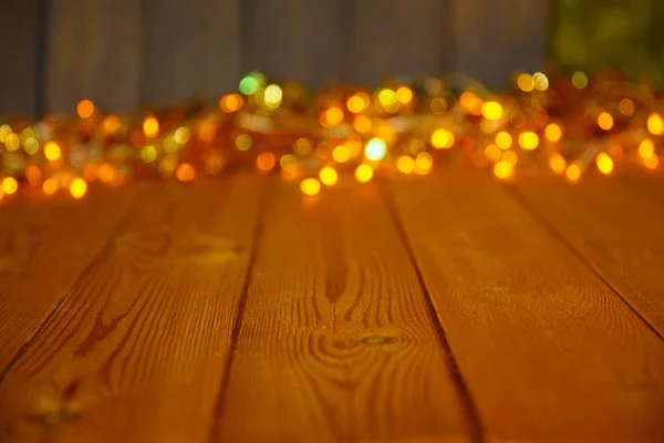 Fundo de madeira com luzes brilhantes com um espaço livre para texto — Fotografia de Stock